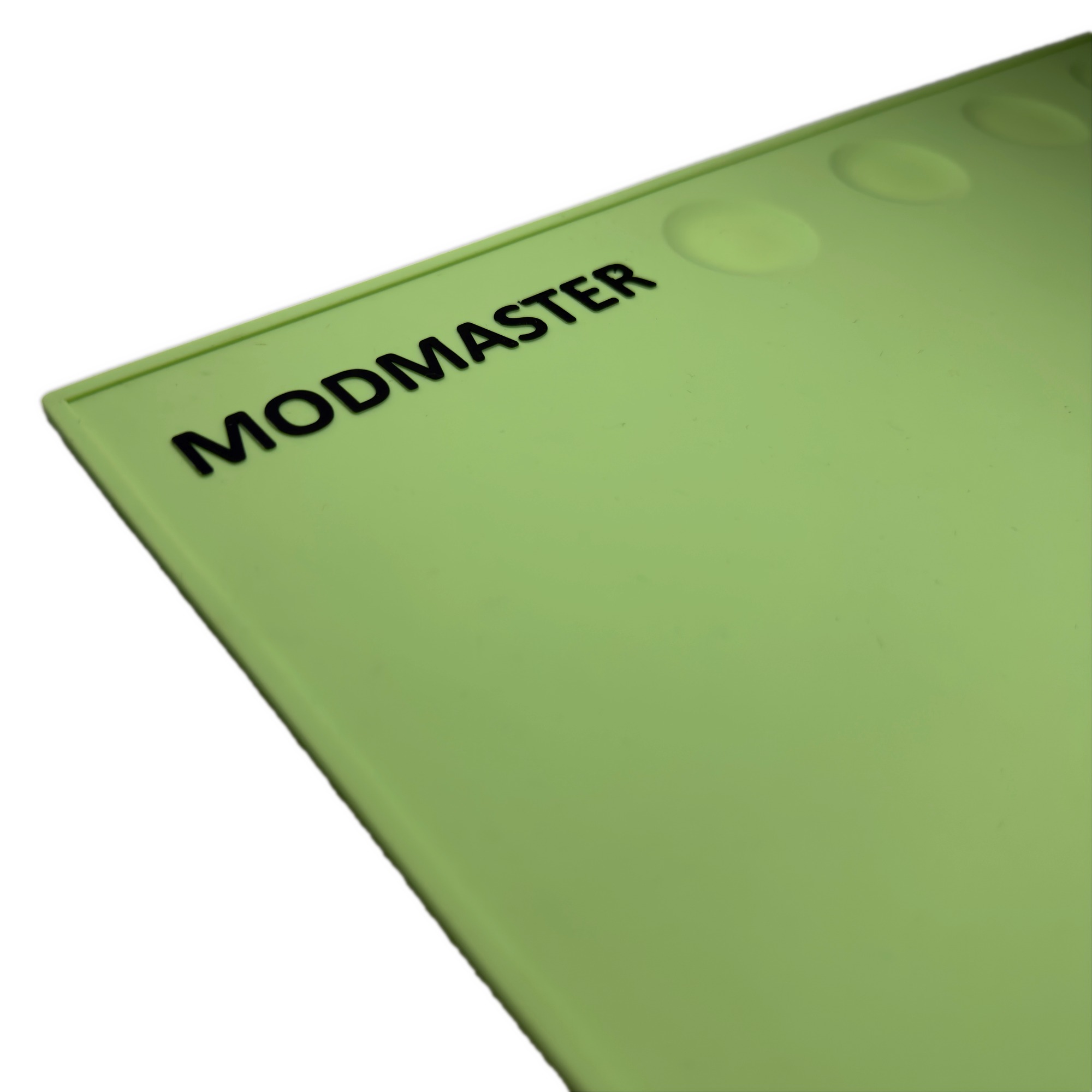 Close-up of the embossed ModMaster wordmark in watchmaker green silicone